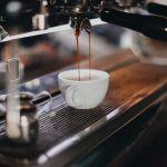 white ceramic cup on brown wooden table